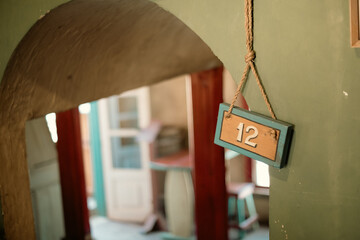 Number 12 in a wooden board interior room