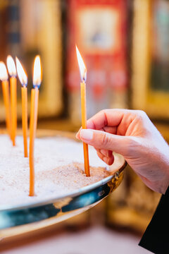 Priest placing candles during a religious ceremony