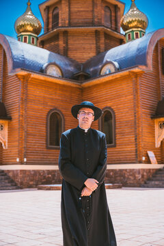 Catholic priest outside an Orthodox church in Altea, Spain