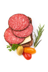 Peppered salami slices, isolated on white background.