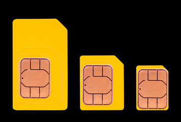 yellow mini, micro and nano SIM cards isolated on a black background top view
