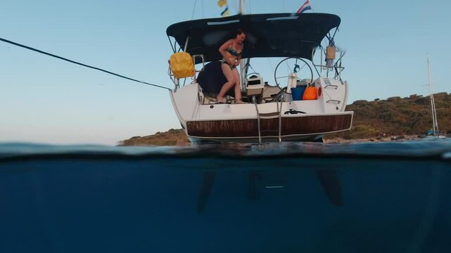 Woman on a yacht enjoying summer vacation. Over and Under