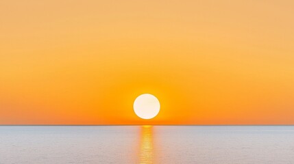 Obraz premium Golden sunset over a calm sea, clear weather, warm glow on the horizon