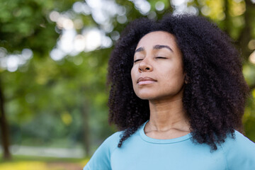 Woman embracing mindfulness in tranquil outdoor environment, eyes closed in peaceful meditation. Connection with nature promotes relaxation and inner peace, enhancing mental well-being