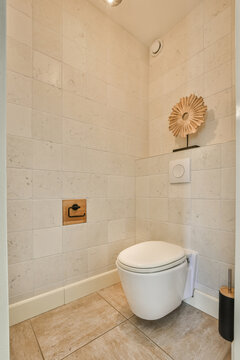 Modern toilet in a clean white-tiled bathroom