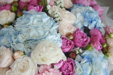 Beautiful delicate floral background. White, light blue, pink roses and hydrangeas. Fragment of a flower bouquet.