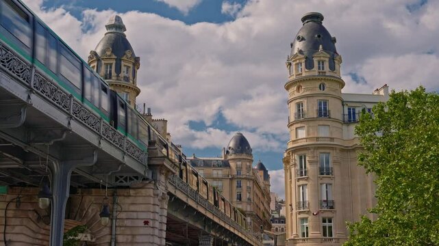 Establishing shot of Paris. The movement of the subway train in the city center. The green train is moving along the rails. Public transport of the modern city. Moving people around Paris