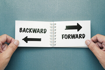 Closeup hand taking an opened notepad on the desk, make a decision to turn the page forward or...