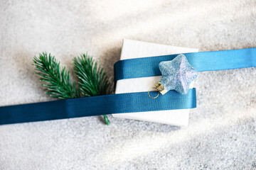 Elegant Christmas gift with festive blue ribbon and star ornament