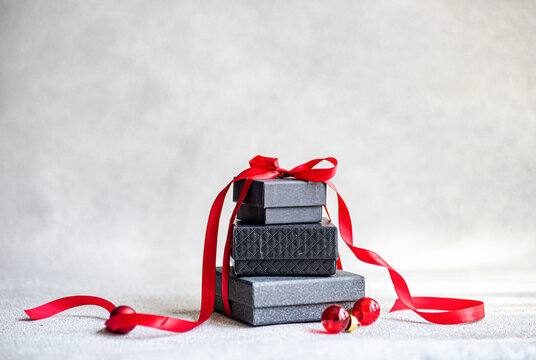 Christmas gift boxes with red ribbon on gray background