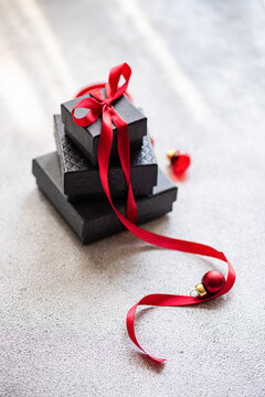 Stacked Christmas gifts with red ribbon and decorations