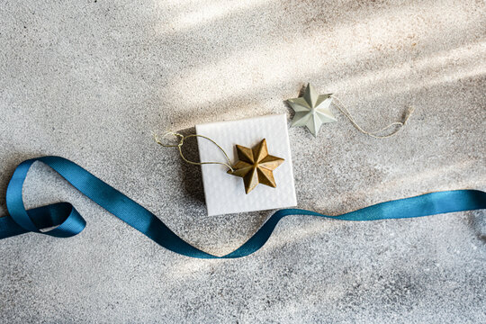 Elegant Christmas gift and decorations from above on textured background