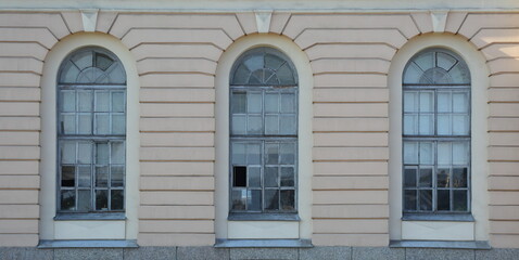 Three arched windows on the ground floor of the house