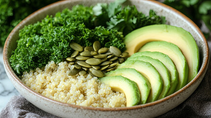 Healthy quinoa salad bowl with kale, avocado, and pumpkin seeds prepared in a rustic kitchen setting