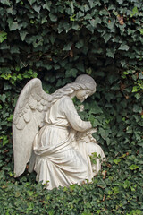 an angel statue made from a light stone