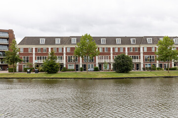 Residential housing in The Netherlands with canal passing in the foreground