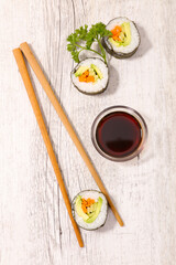 maki sushi food with soy sauce and chopsticks