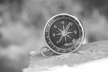 Classic navigation compass on natural background