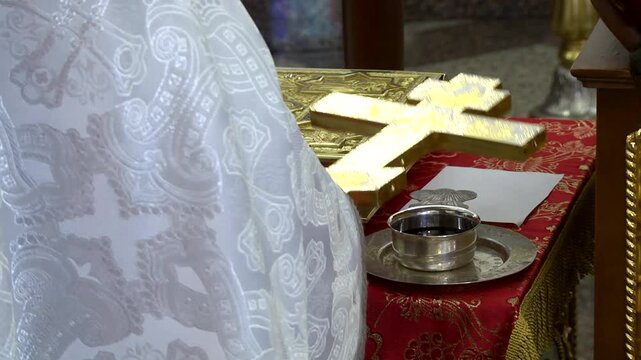 priest baptizing wine in the temple before the wedding ceremony