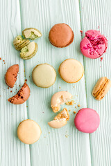sweet dessert pattern with macarons on mint green background flat lay pattern