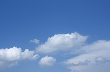 Fototapeta premium A blue sky with puffy clouds.