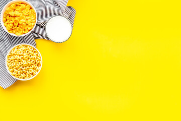 Cereals and flakes from corn and oat on yellow background top view mockup