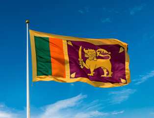 The flag of Sri Lanka fluttering in the wind with blue sky background