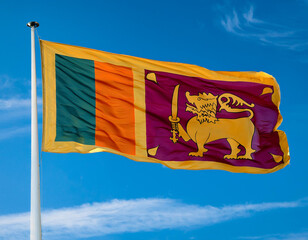 The flag of Sri Lanka fluttering in the wind with blue sky background