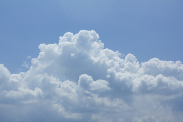 A blue sky with puffy clouds.