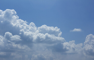 A blue sky with puffy clouds.