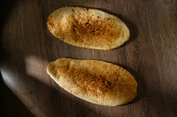 Pita on a wooden background, side view, selective focus.