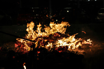 Chinese hungry ghost festival prayer offering joss paper money candle burning fire flame smoke