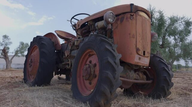 Old abandoned tractors in the countryside, front view from below