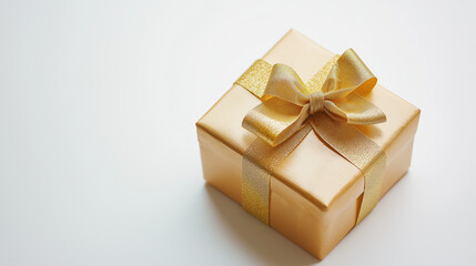 Elegant golden gift box with ribbon on white background highlighting luxury and celebration