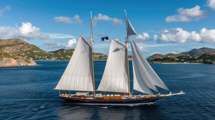 A classic sailing yacht showcases its tall masts and full white sails as it navigates the calm Caribbean waters, with fluffy clouds and islands on the horizon