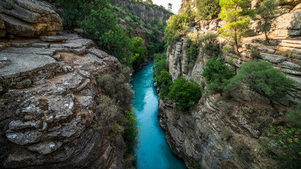 Koprulu Canyon. A close-up of the deep blue stormy mountain river that runs through the trees in Koprulu Canyon.