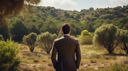 Back of businessman looking at destroyed forest