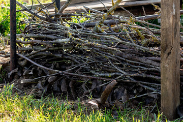 Dry hedge or Benjes hedge made of maintenance pruning branches, dead wood and roots,...