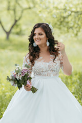 A woman in a white dress is holding a bouquet of flowers. She is smiling and she is happy. Concept of joy and celebration, as the woman is likely attending a special event