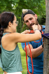 Fototapeta premium Focus on Wellness: Sports Couple Ready to Train with Resistance Bands Outdoors