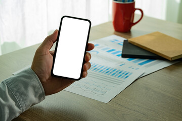 Top view Mockup image hand using a smartphone man Holding Cell Phone With Blank Screen