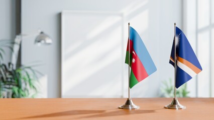 FLAGS OF AZERBAIJAN AND MARSHALL ISLANDS ON TABLE