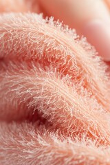 Soft textured fabric close-up with warm pink tones
