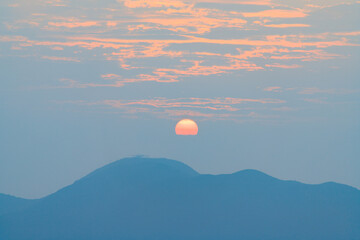 Serene Sunrise Over Distant Mountain Peaks