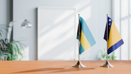 FLAGS OF BAHAMAS AND BOSNIA ON TABLE