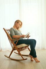 Pregnant, woman and reading in house, tablet and information for health, online and ebook for baby....