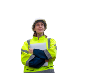 Engineers wearing safety gear, including hard hats examining survey a tablet standing industrial facility gas task or oil refinery engaged in a job requires high safety standards concept