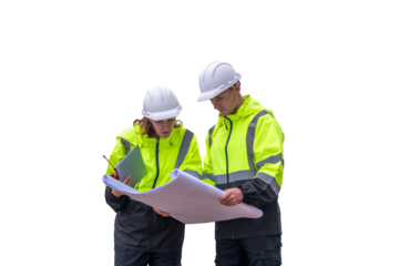 Engineers wearing safety gear, including hard hats examining survey a tablet standing industrial facility gas task or oil refinery engaged in a job requires high safety standards concept
