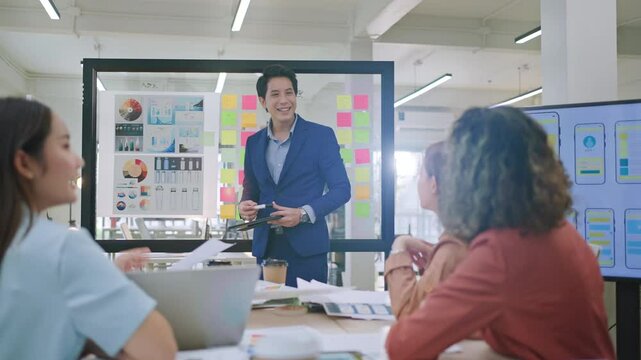 Group of young asian creative business brain storm meeting presentation,discussing roadmap to product launch, planning,strategy,new business development,working with new startup project in office.

