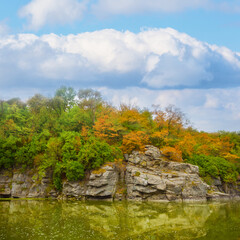 river flow through canyon under a blue cloudy sky